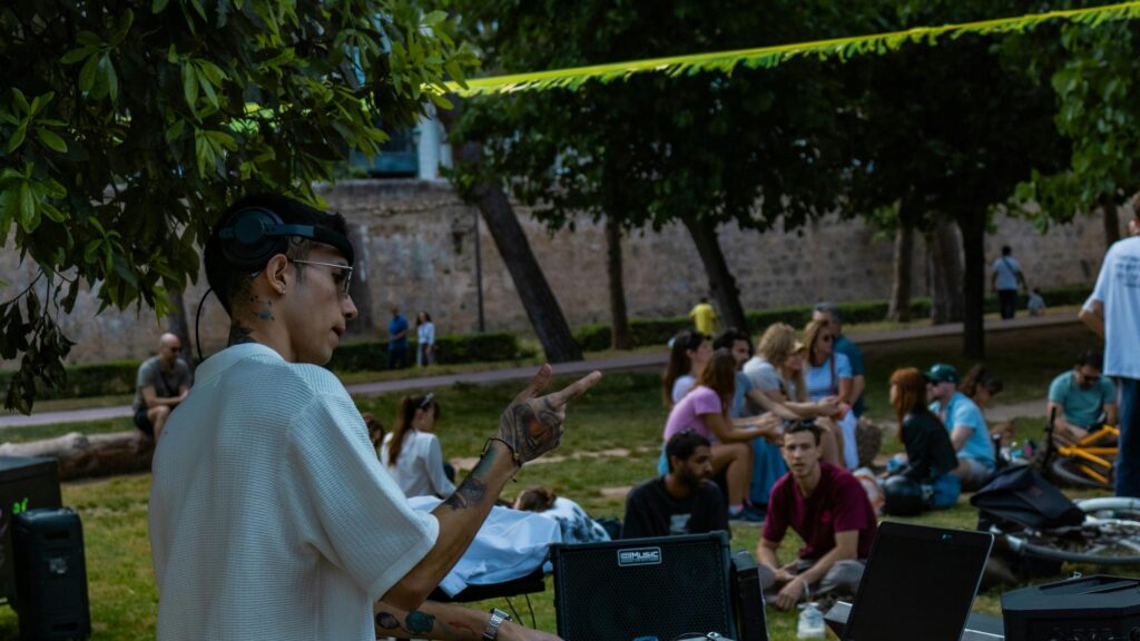 DJ Performing in a Sunny Urban Park 4K Desktop Wallpaper