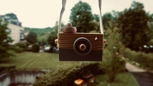 Charming Wooden Toy Camera Hanging in Garden 4K Desktop Wallpaper