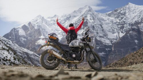 Biker Celebrating at Snow Mountain Peaks 4K Desktop Wallpaper