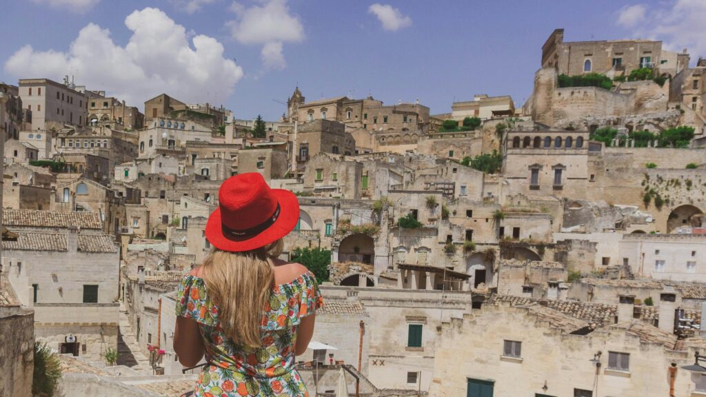Woman Looking at Ancient Cave Dwellings of Matera Italy 4K Wallpaper