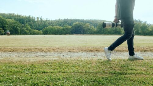 Professional Sports Photographer Walking on Field Desktop Wallpaper