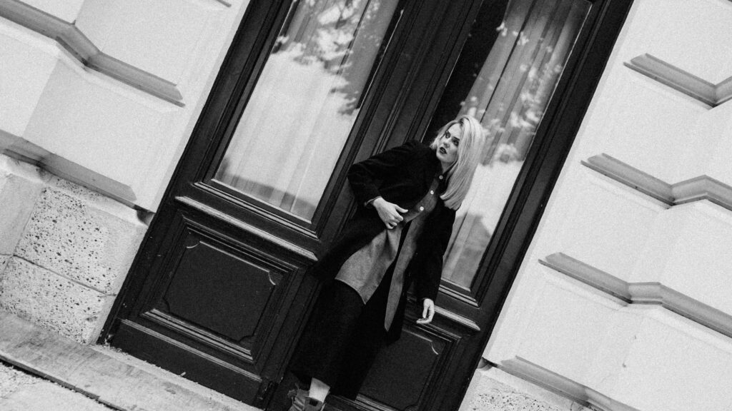 Stylish Woman Standing by Antique Wooden Door Black and White Desktop Wallpaper