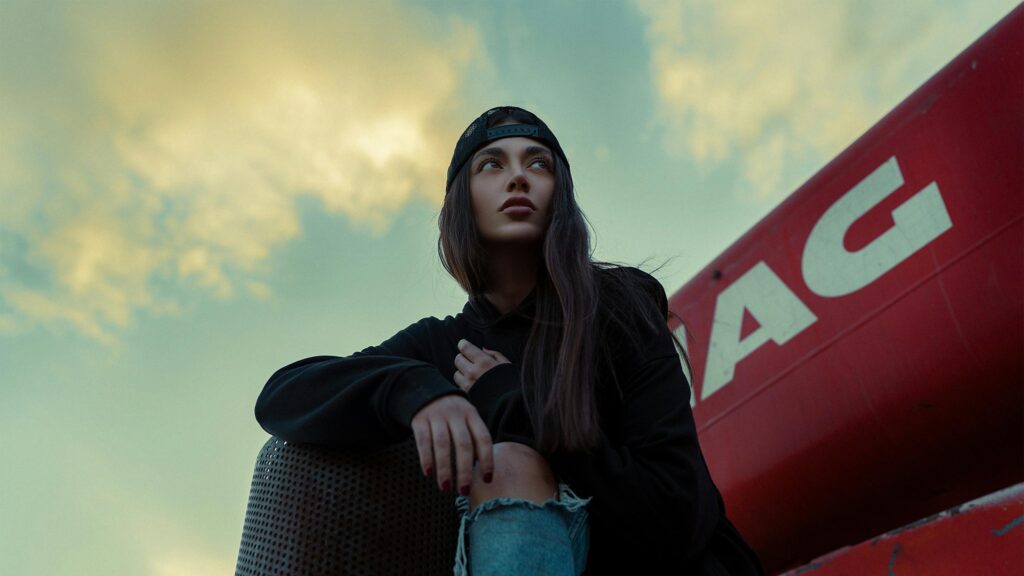 Stylish Girl in Black Hoodie and Cap Looking Away Desktop Wallpaper