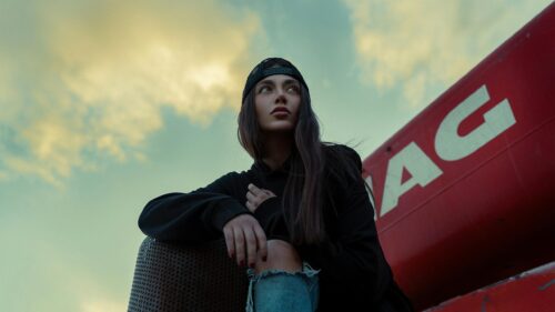 Stylish Girl in Black Hoodie and Cap Looking Away Desktop Wallpaper