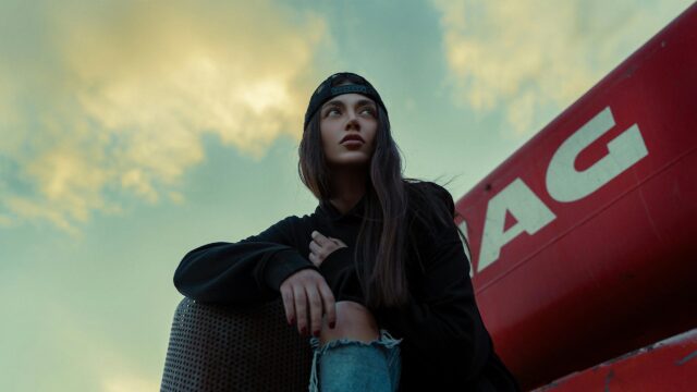 Stylish Girl in Black Hoodie and Cap Looking Away Desktop Wallpaper