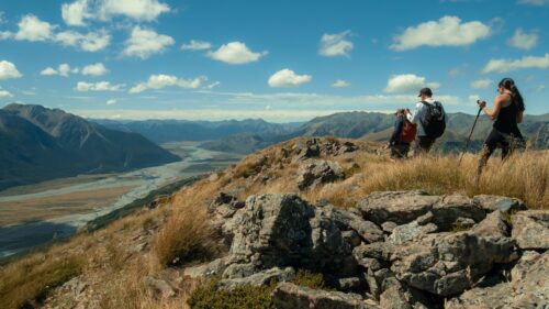 Hikers Overlooking Mountain Valley Landscape 4K Wallpaper
