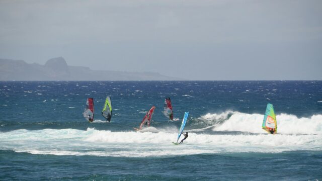 Thrilling Windsurfing Action in Choppy Ocean Waters Desktop Wallpaper