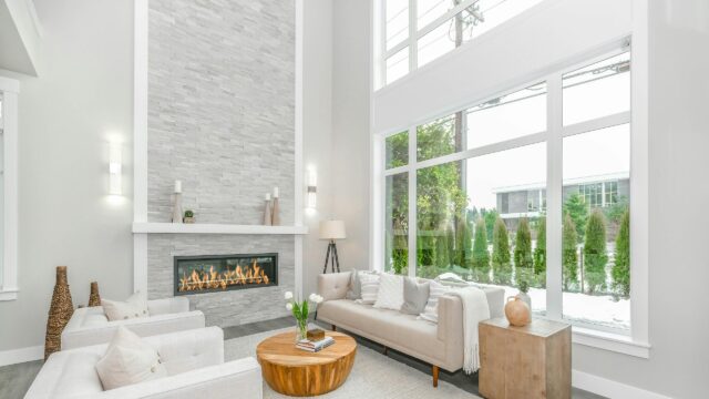 Modern Luxury Living Room with Fireplace and Large Windows Desktop Wallpaper