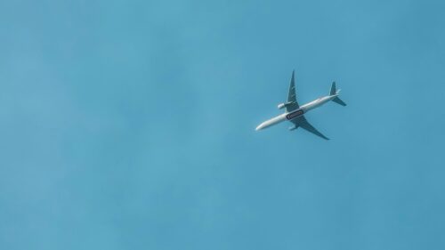 Emirates Passenger Plane Flying Through Clear Blue Sky 4K Wallpaper
