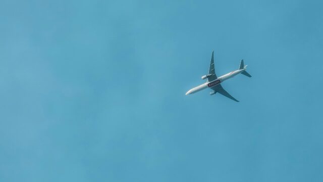 Emirates Passenger Plane Flying Through Clear Blue Sky 4K Wallpaper