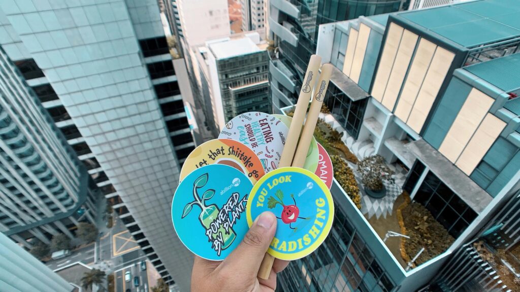 Funny Plant-Based Food Stickers Handheld Over Cityscape 4K Wallpaper