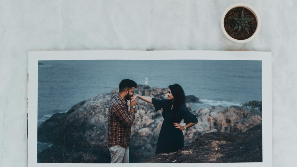 Romantic Couple Kissing Hand on Rocky Coastline 4K Desktop Wallpaper