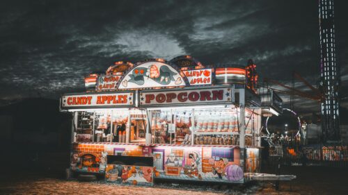 Vintage Carnival Popcorn and Candy Apple Stand at Night 4K Wallpaper