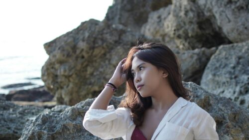 Beautiful Young Asian Woman Posing Near Coastal Rocks Desktop Wallpaper