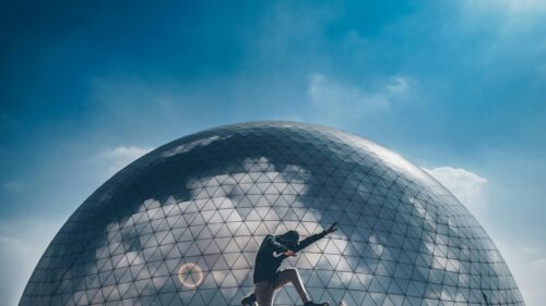 Silhouette of a Dancer in Front of a Futuristic Glass Geodesic Dome Desktop Wallpaper