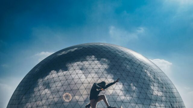 Silhouette of a Dancer in Front of a Futuristic Glass Geodesic Dome Desktop Wallpaper