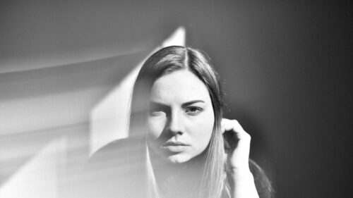 Monochromatic Portrait of Young Woman with Shadow Play 4K Wallpaper