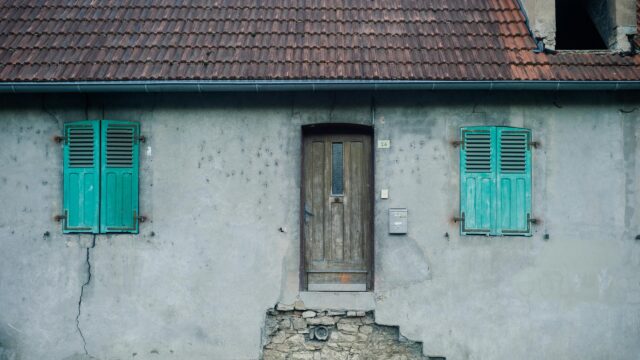 Rustic Abandoned House with Teal Shutters 4K Desktop Wallpaper