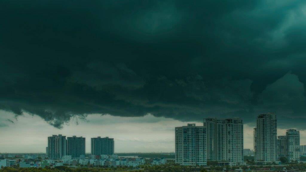 Dramatic Storm Clouds Over Modern City Skyscraper Desktop Wallpaper