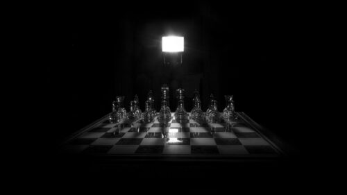 Dramatic Glass Chess Set Under Spotlight 4K Desktop Wallpaper