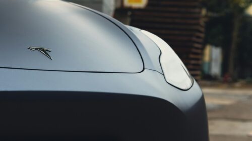 Sleek Matte Grey Tesla Logo Front Detail 4K Wallpaper
