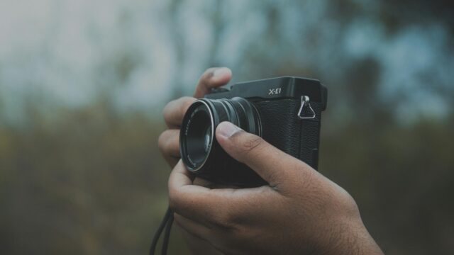 Hands Holding Fujifilm X-E1 Vintage Camera Desktop Wallpaper