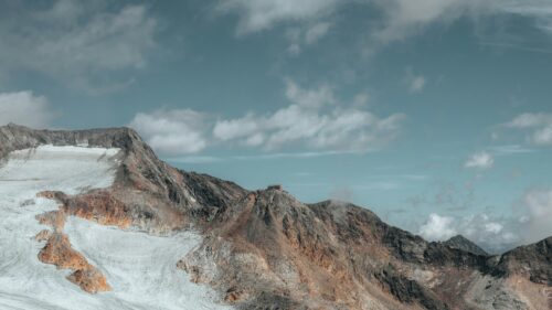 Mountain Hut on Alpine Glacier Ridge 4K Wallpaper
