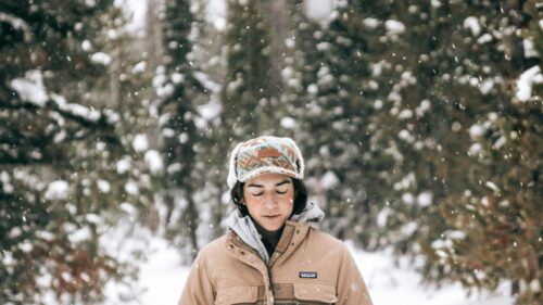 Woman Wearing Winter Hat in Snowy Forest 4K Desktop Wallpaper
