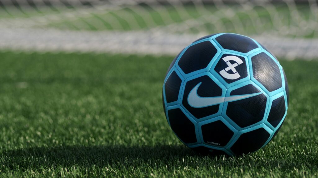 Nike Strike X Soccer Ball on Grass Field Desktop Wallpaper