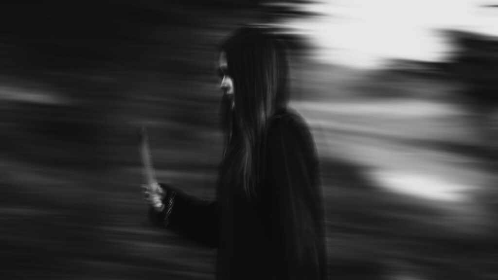 Eerie Dark Silhouette with Blade Motion Blur 4K Wallpaper