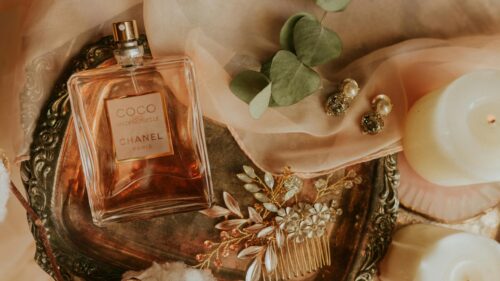 Elegant Chanel Perfume and Floral Hair Accessory Desktop Wallpaper