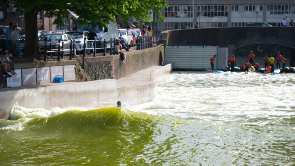 Urban River Surfing Action on a Sunny Day Desktop Wallpaper