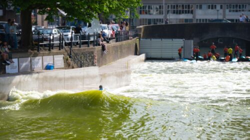 Urban River Surfing Action on a Sunny Day Desktop Wallpaper