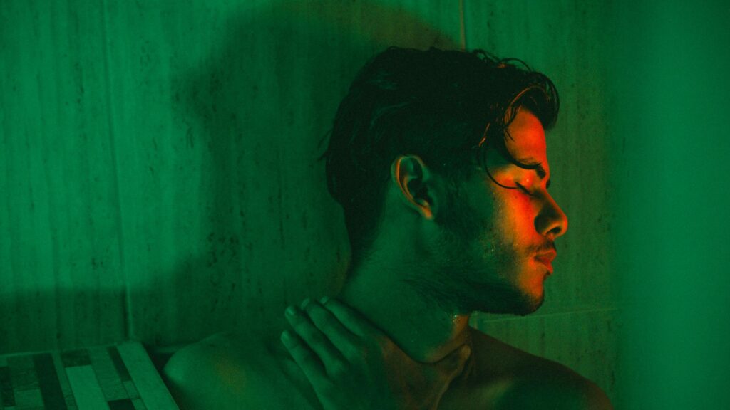 Moody Portrait of a Young Man in Green and Red Neon Light Desktop Wallpaper