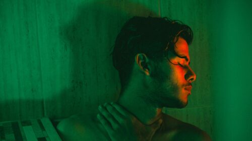 Moody Portrait of a Young Man in Green and Red Neon Light Desktop Wallpaper