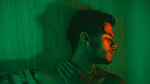 Moody Portrait of a Young Man in Green and Red Neon Light Desktop Wallpaper