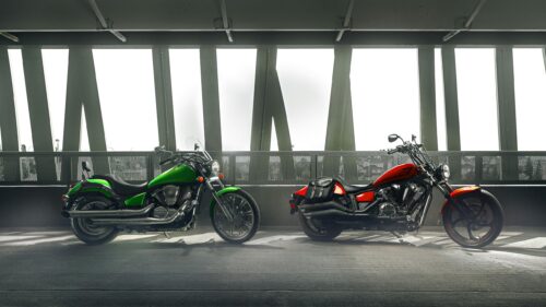 Two Custom Cruiser Motorcycles in Parking Garage 4K Wallpaper