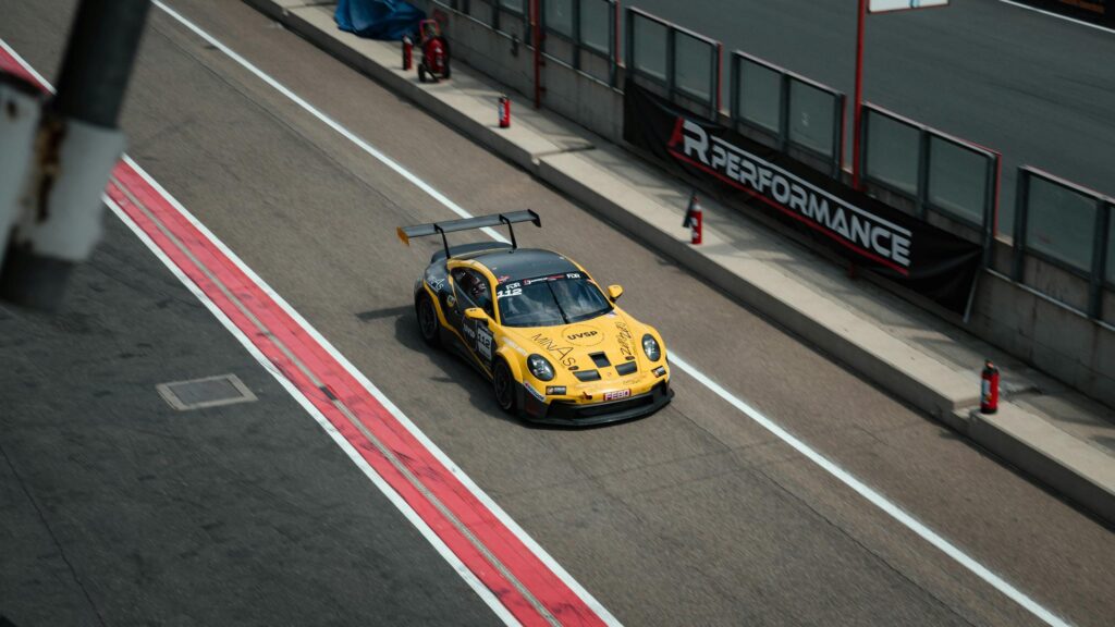 Yellow Porsche 911 GT3 Race Car on Circuit Track 4K Wallpaper