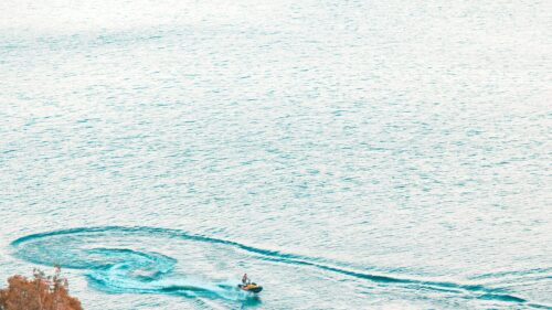 Person Riding a Jet Ski in the Calm Blue Ocean Desktop Wallpaper