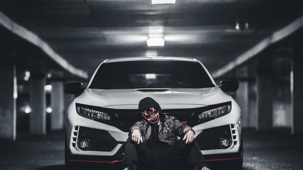 Edgy Hooded Figure with Glowing Mask in Front of Honda Civic Type R 4K Wallpaper