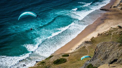 Extreme Paragliding Over Turquoise Ocean Beach 4K Wallpaper