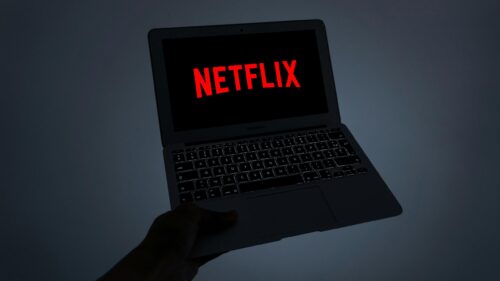 Netflix Logo on MacBook Air Screen Dark Cinematic Desktop Wallpaper