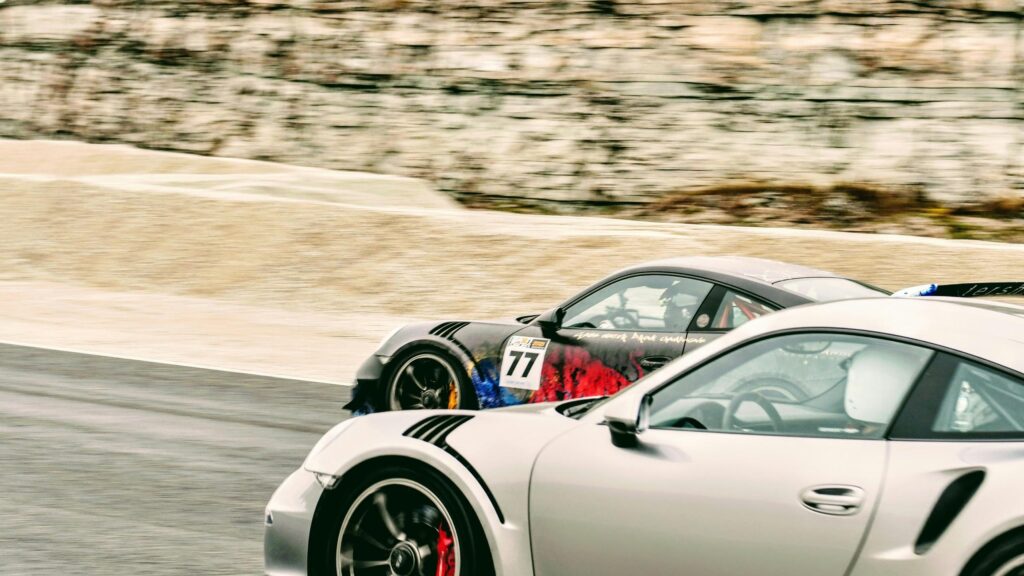 Racing Porsches Speeding on Track Desktop Wallpaper