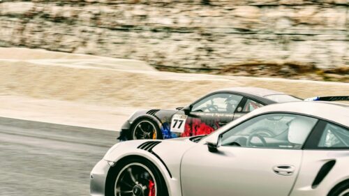 Racing Porsches Speeding on Track Desktop Wallpaper