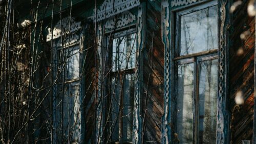 Rustic Wooden House with Ornate Window Frames Desktop Wallpaper