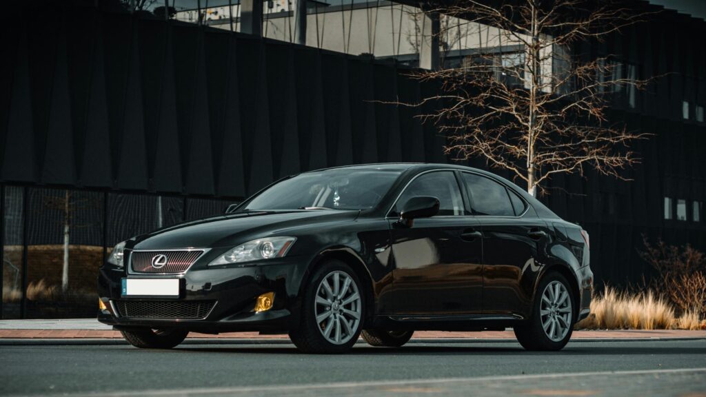 Sleek Black Lexus IS Sedan Standing Outdoors 4K Wallpaper