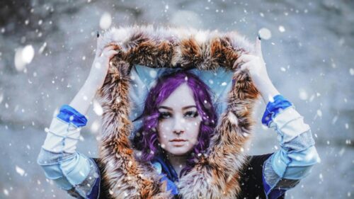 Stunning Purple Hair Cosplayer with Fur Hood in Snow 4K Wallpaper