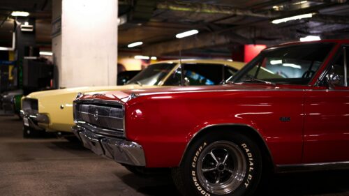 Classic Red Dodge Charger and Yellow Muscle Car in Parking Garage 4K Wallpaper
