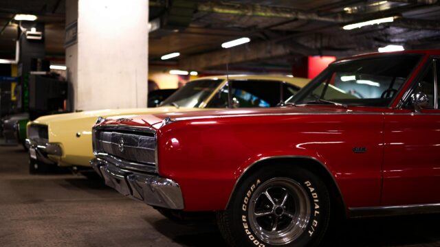 Classic Red Dodge Charger and Yellow Muscle Car in Parking Garage 4K Wallpaper