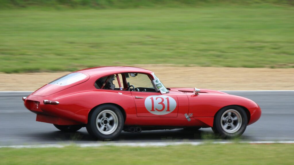 Classic Red Jaguar E-Type Racing Car on Track Desktop Wallpaper